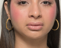 Baby Bri hoop earrings by coco + peach jewelry worn by a Latina model
