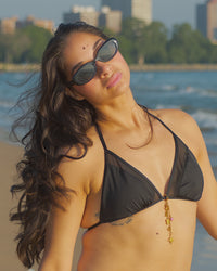 Lisa waterproof bikini charm by coco + peach jewelry clipped to a bikini 