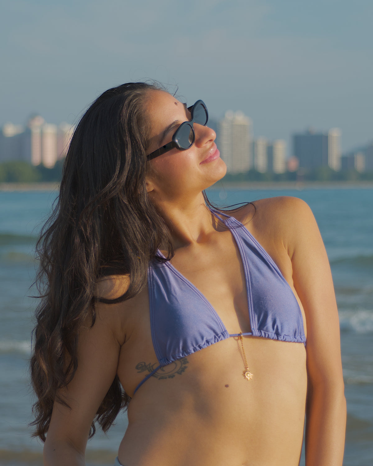 Patty sunshine waterproof bikini charm by coco + peach jewelry clipped on a bikini
