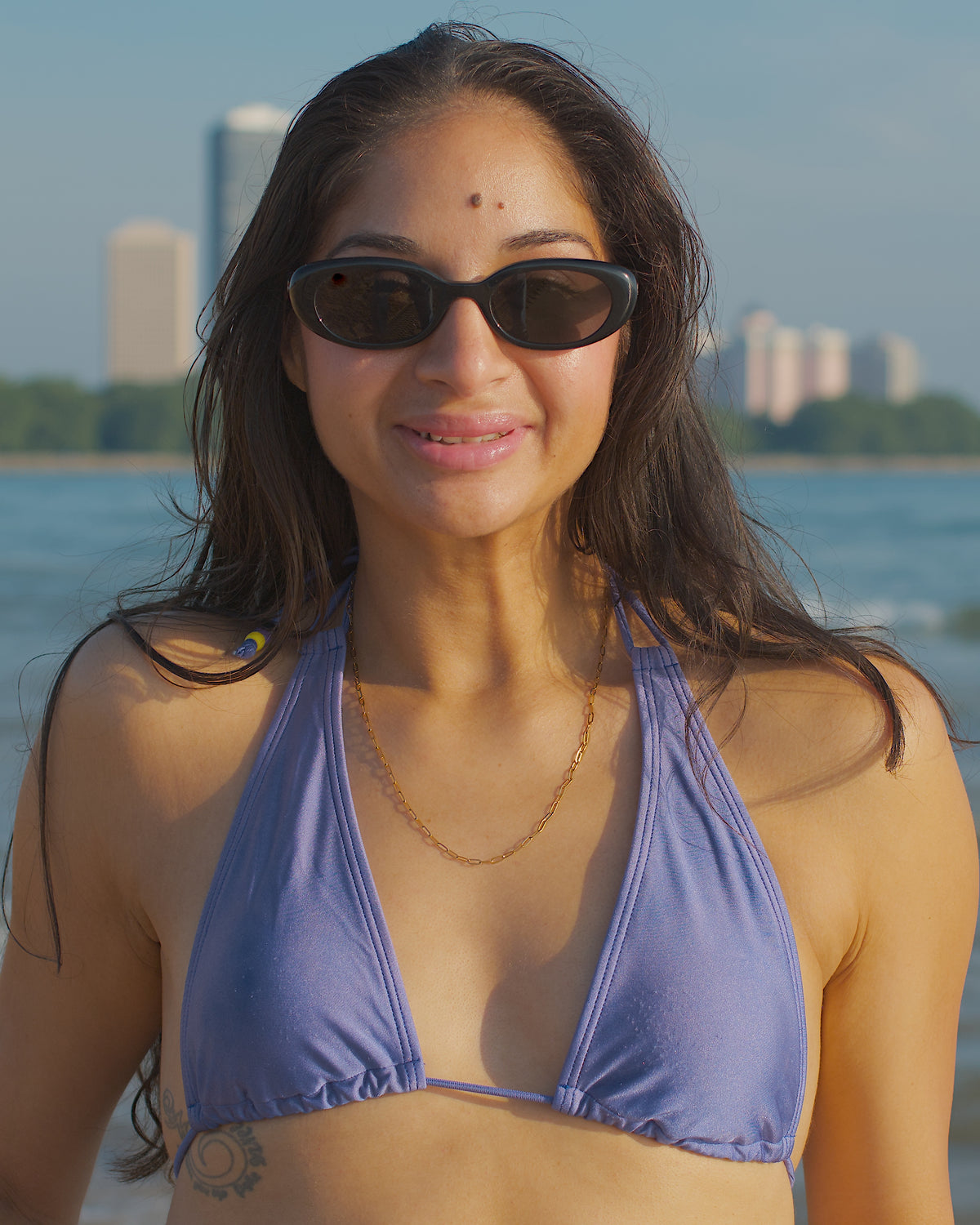 Robbie paperclip necklace in gold waterproof tarnish-resistant jewelry from the Sirena collection styled for everyday wear on a beach