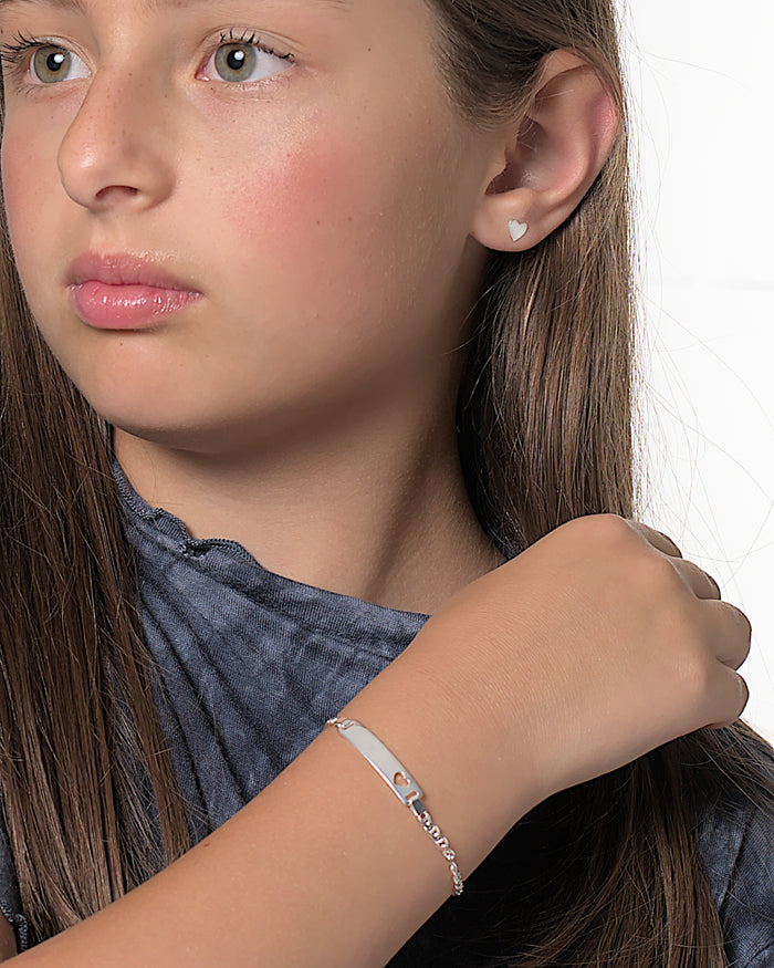 Viviana silver heart stud earrings worn by a Latina kid model
